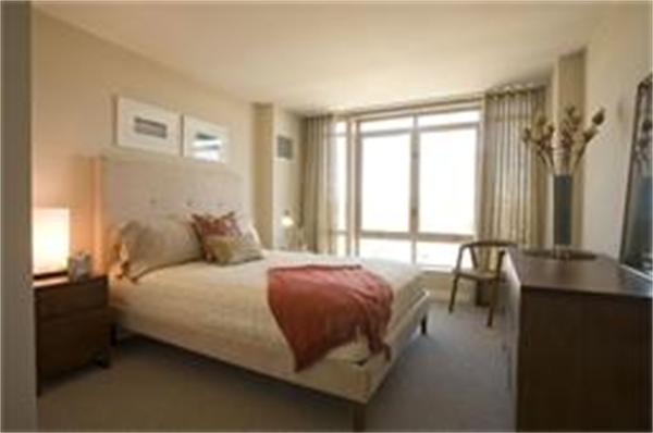 1910 Dorchester Avenue, Unit 517 Boston, MA 02124 - Photo 11 of 15 a bedroom with a bed and a window