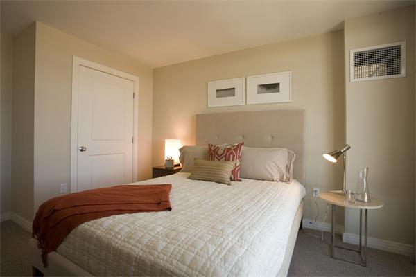 1910 Dorchester Avenue, Unit 517 Boston, MA 02124 - Photo 12 of 15 a bedroom with a bed and a lamp