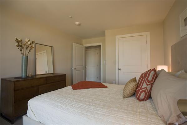 1910 Dorchester Avenue, Unit 517 Boston, MA 02124 - Photo 13 of 15 a bedroom with a bed and a night stand
