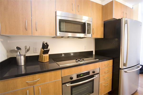 1910 Dorchester Avenue, Unit 517 Boston, MA 02124 - Photo 10 of 15 a kitchen with granite countertop stainless steel appliances and counter space