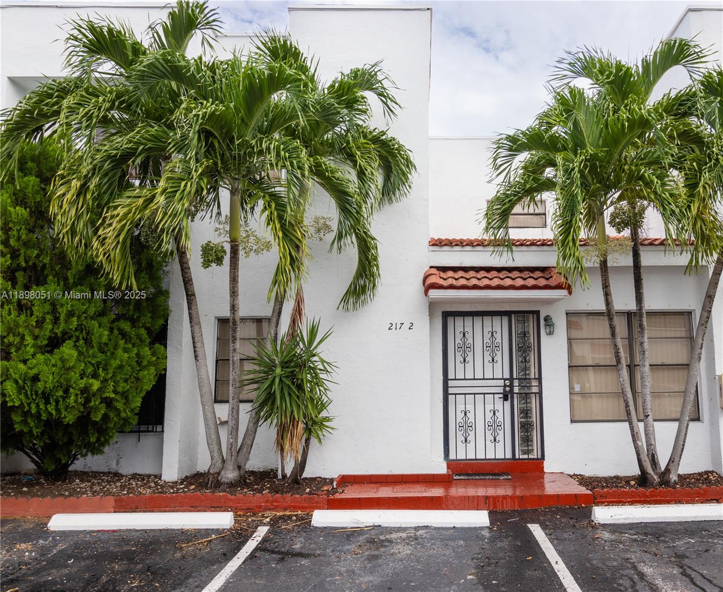 217 Northwest 109th Avenue, Unit 2217 Miami, FL 33172 - Photo 1 of 19 a front view of a house with a tree