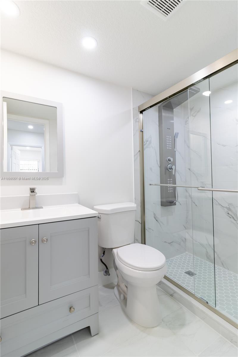 217 Northwest 109th Avenue, Unit 2217 Miami, FL 33172 - Photo 11 of 19 a bathroom with a sink toilet and shower