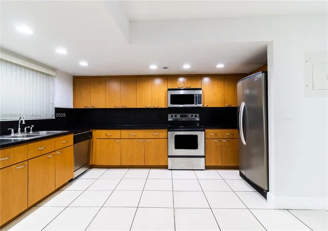 a kitchen with stainless steel appliances granite countertop a sink and cabinets