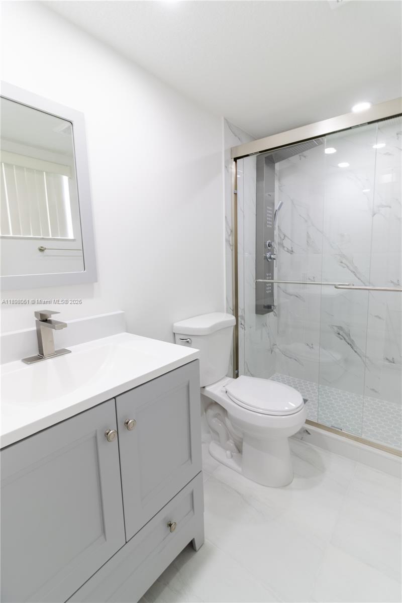 217 Northwest 109th Avenue, Unit 2217 Miami, FL 33172 - Photo 9 of 19 a bathroom with a sink a toilet and shower