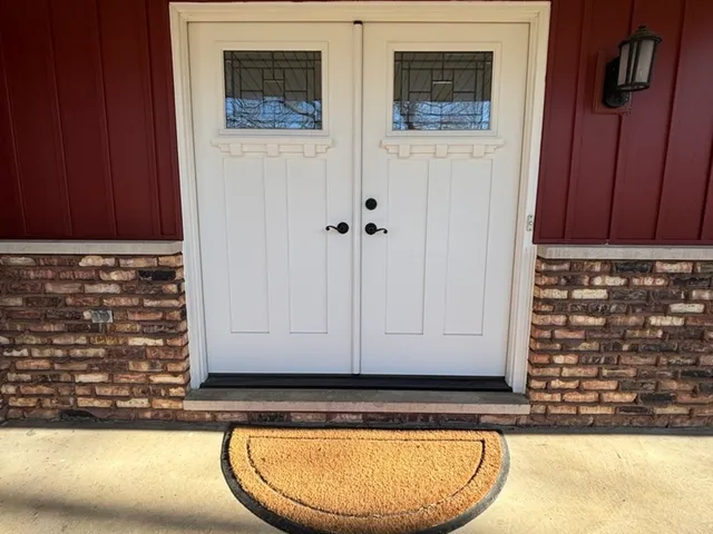 a view of an entryway with wooden floor