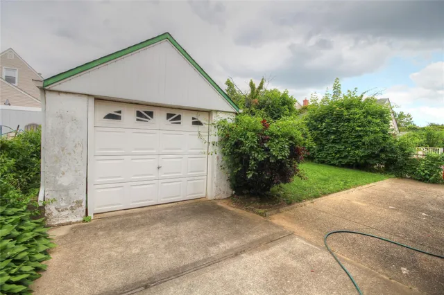 a view of a house with a yard and garage