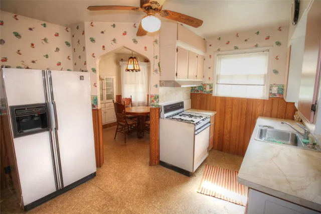 a view of living room with furniture and a refrigerator