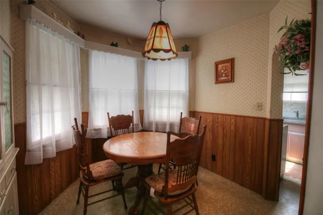 a dining room with furniture and window