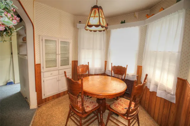 a dining room with furniture and window