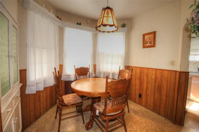 a view of a dining room with furniture and a chandelier