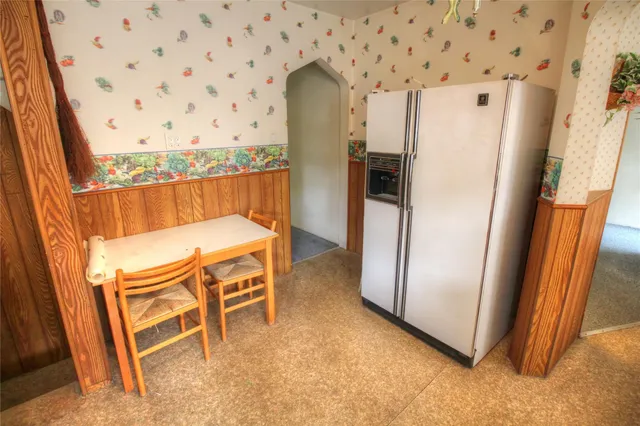 a view of a refrigerator in kitchen and wooden floor