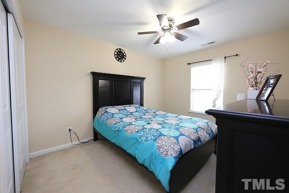 2422 Memory Ridge Drive Raleigh, NC 27606 - Photo 13 of 19 a bedroom with a bed chandelier and a window