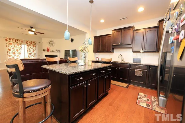 a kitchen with a sink stove and wooden cabinets