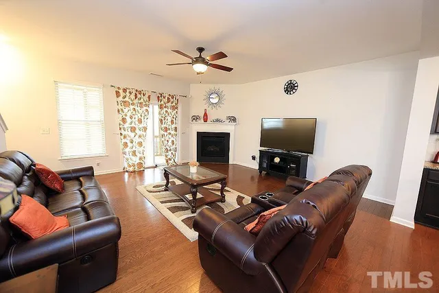 a living room with furniture a fireplace and a flat screen tv