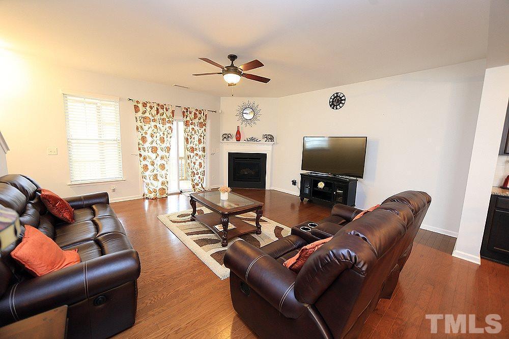 2422 Memory Ridge Drive Raleigh, NC 27606 - Photo 5 of 19 a living room with furniture a fireplace and a flat screen tv
