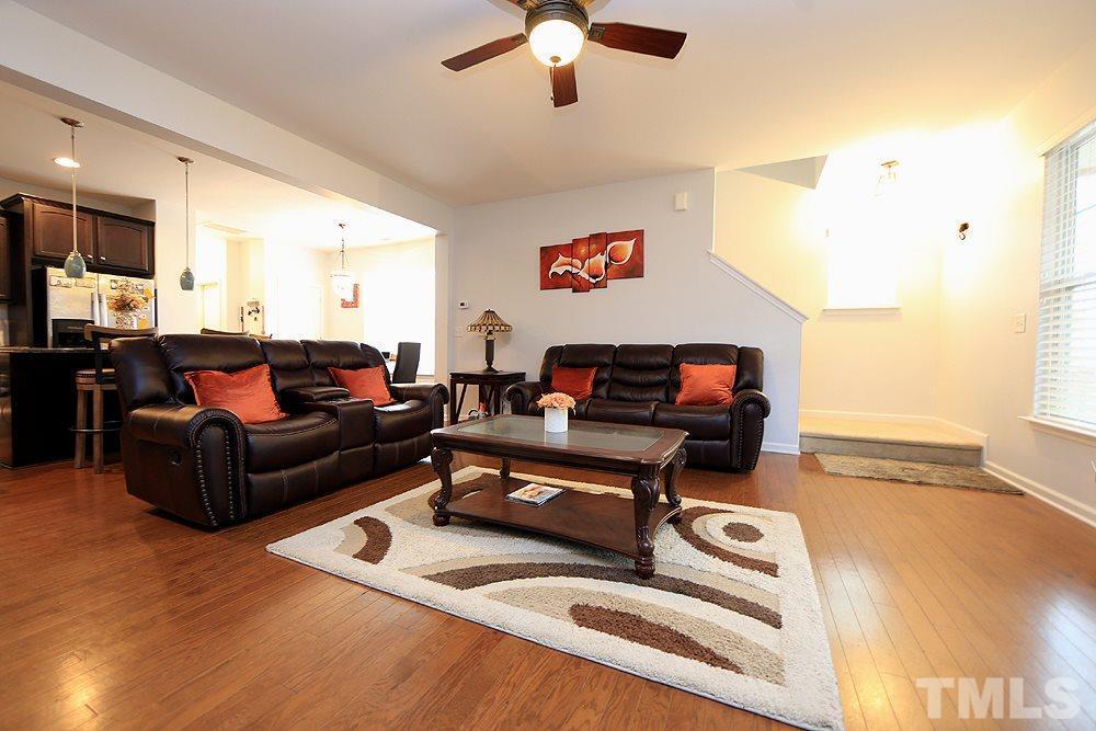 2422 Memory Ridge Drive Raleigh, NC 27606 - Photo 7 of 19 a living room with furniture and a flat screen tv with kitchen view