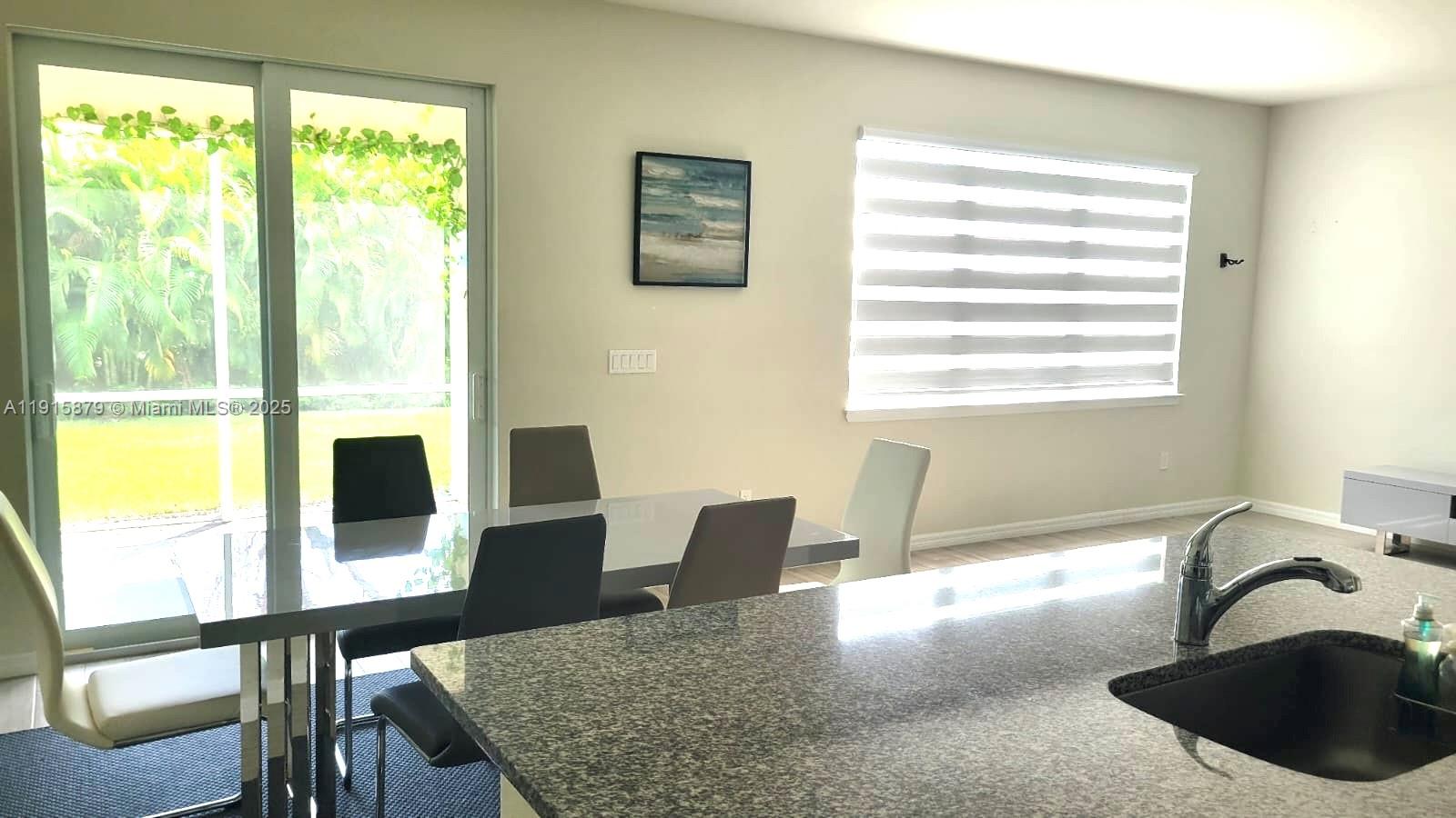 4164 Ficus Street Hollywood, FL 33021 - Photo 15 of 16 a view of a dining room with furniture window and outside view