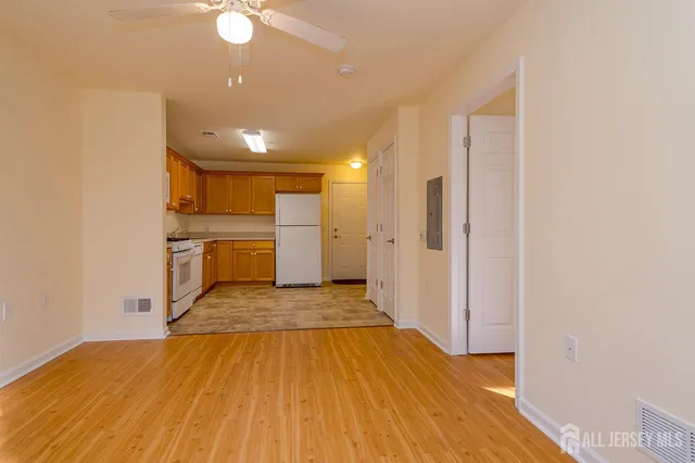 a view of a kitchen with a sink and a refrigerator