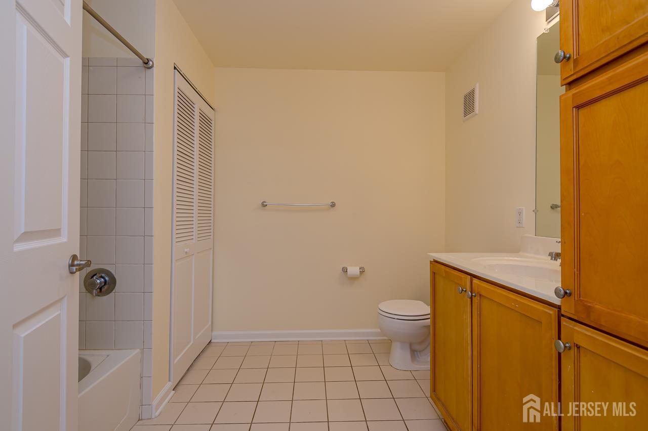 99 Liddle Avenue Edison, NJ 08837 - Photo 7 of 15 a bathroom with a granite countertop toilet and a shower