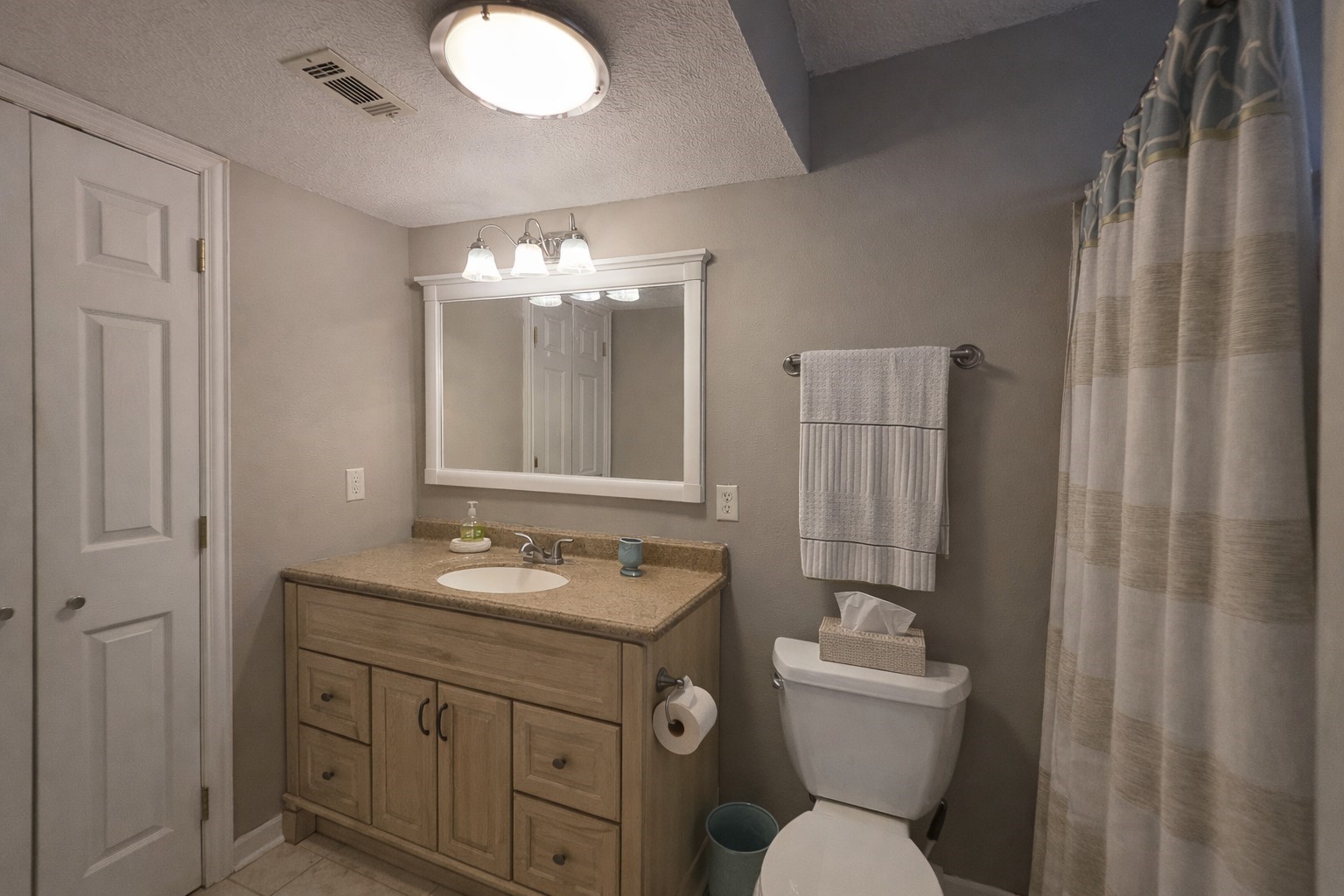 145 Cypress Road Livingston, TX 77351 - Photo 6 of 16 This bathroom is cozy and well-lit, featuring a single-sink vanity with ample storage, a large mirror, and neutral tones.