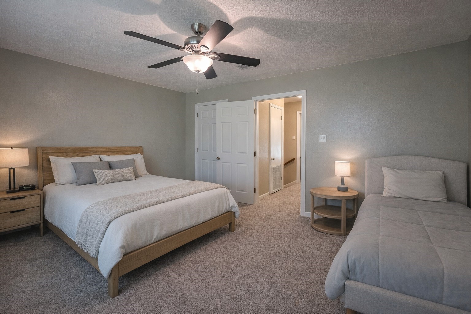 145 Cypress Road Livingston, TX 77351 - Photo 9 of 16 This bedroom features a cozy setup with a double bed and a single bed, carpeted floor, neutral walls, ceiling fan, and access to a hallway or bathroom. Mirroring the investors vision.