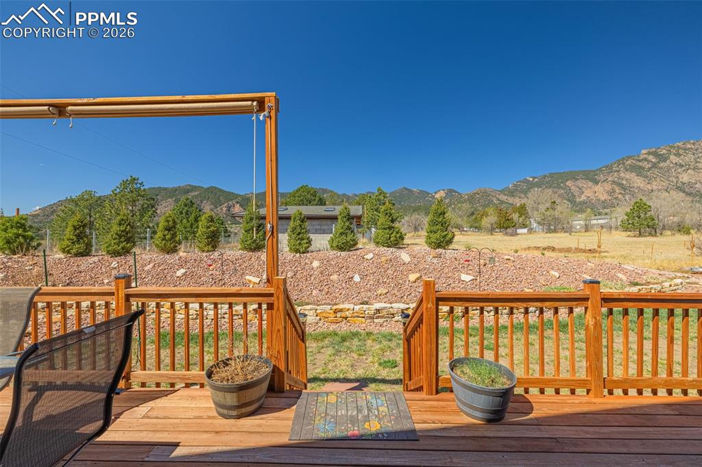 8480 Delaware Road Colorado Springs, CO 80926 - Photo 31 of 49 Wooden deck featuring a mountain view
