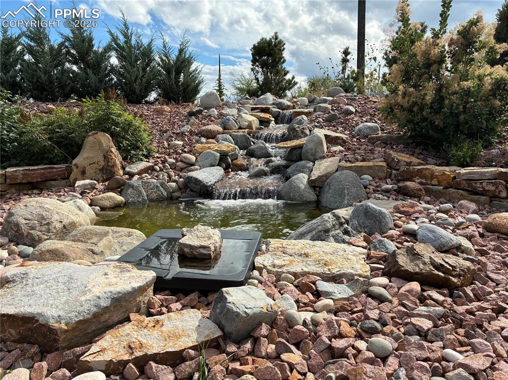 8480 Delaware Road Colorado Springs, CO 80926 - Photo 45 of 49 Summer 2025 view of the water feature