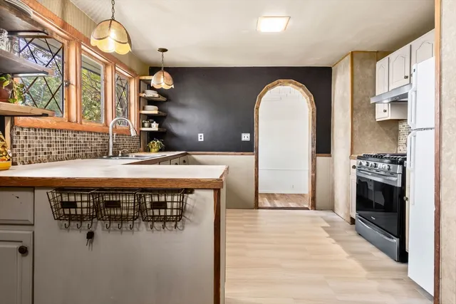 a hall with a stove a washer and dryer