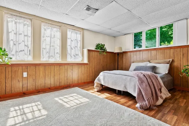 a bedroom with a large bed and potted plant