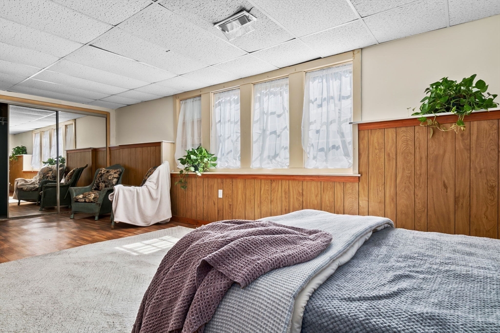 38 Pickering Street Danvers, MA 01923 - Photo 27 of 39 a bedroom with a large bed and potted plant