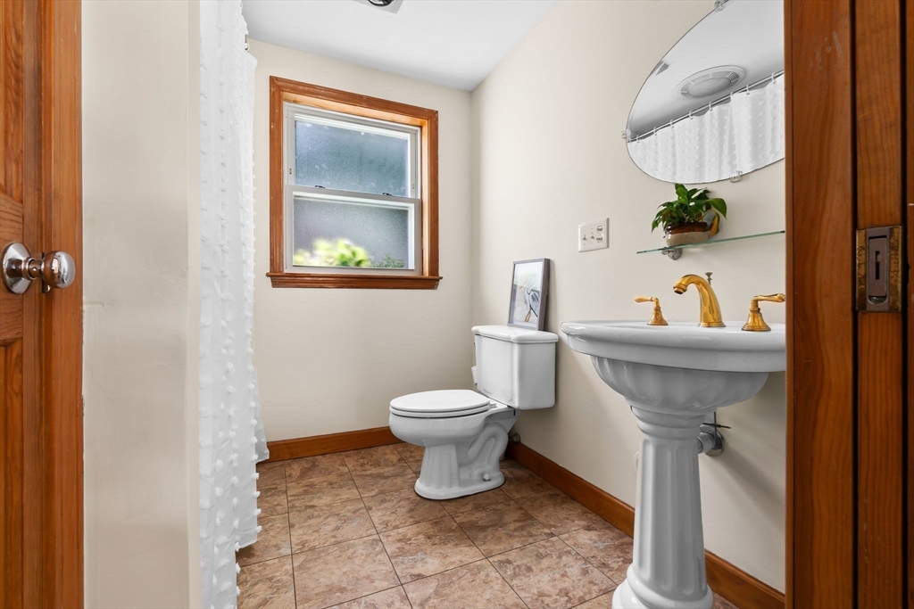 38 Pickering Street Danvers, MA 01923 - Photo 28 of 39 a bathroom with a toilet sink and mirror