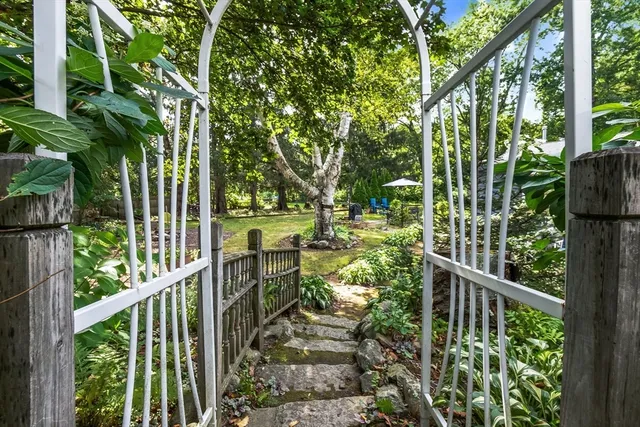 a view of a house with backyard and sitting area
