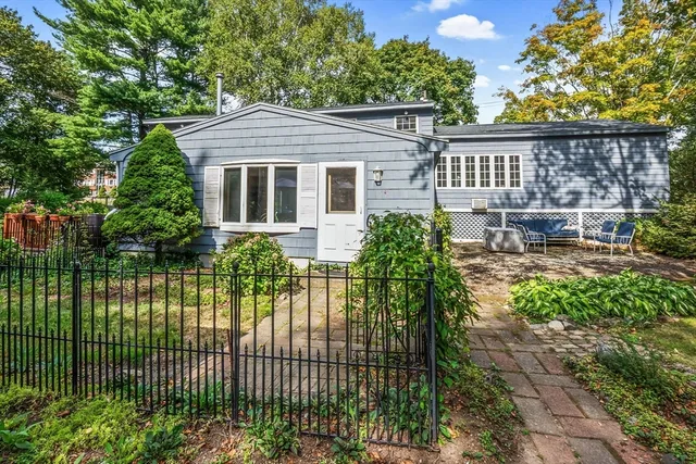 a view of a chair and table in the garden