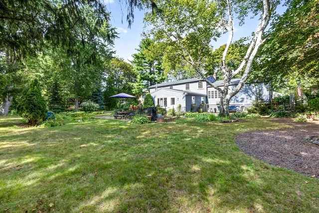 a backyard of a house with yard and outdoor seating