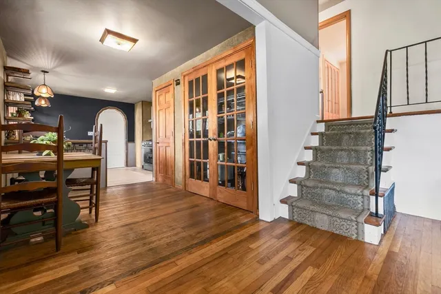 a view of a living room with furniture and wooden floor