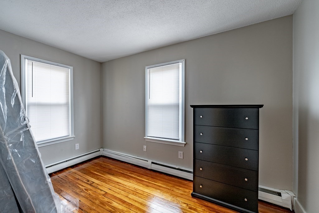 254-256 Main Street Springfield, MA 01151 - Photo 17 of 34 a view of a room with window and wooden floor