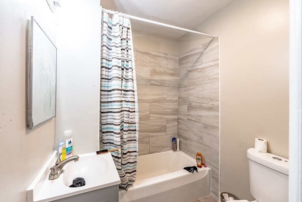 254-256 Main Street Springfield, MA 01151 - Photo 5 of 34 a bathroom with a sink and a bathtub