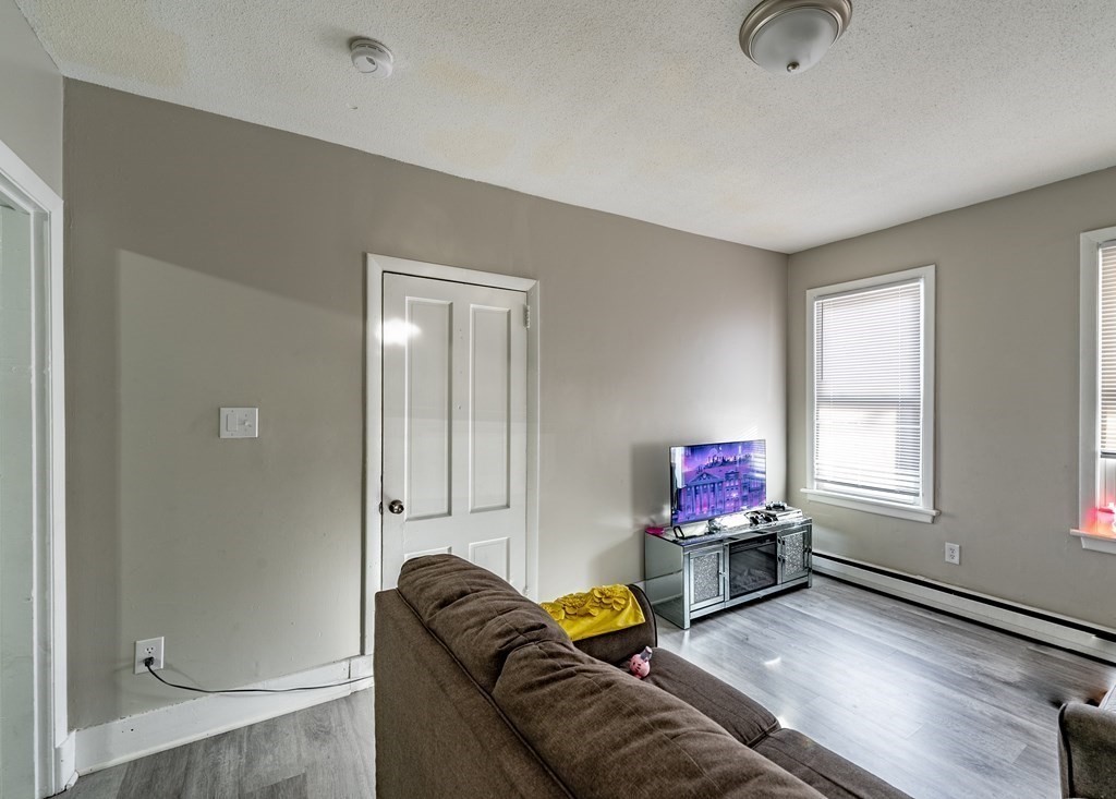254-256 Main Street Springfield, MA 01151 - Photo 8 of 34 a living room with furniture and a window