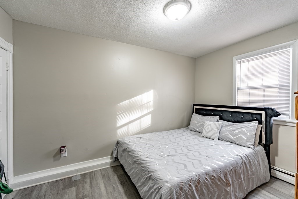 254-256 Main Street Springfield, MA 01151 - Photo 9 of 34 a bedroom with a bed and a window