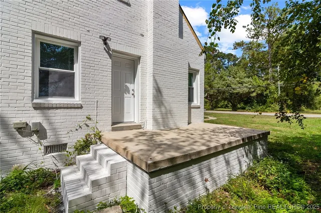 a view of an house with backyard space and balcony
