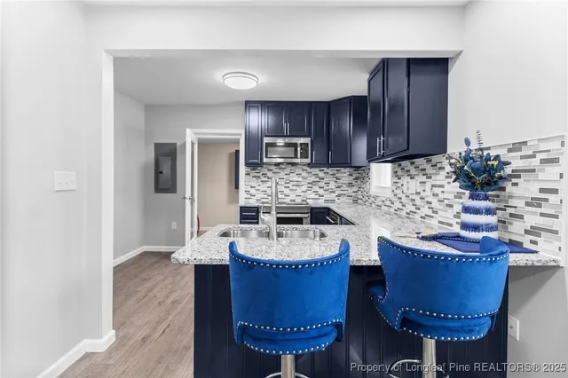 a kitchen with sink a refrigerator and a stove