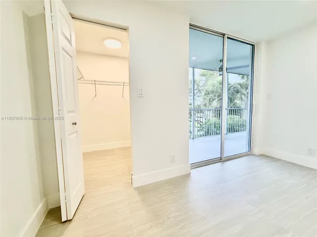a view of an empty room with glass door
