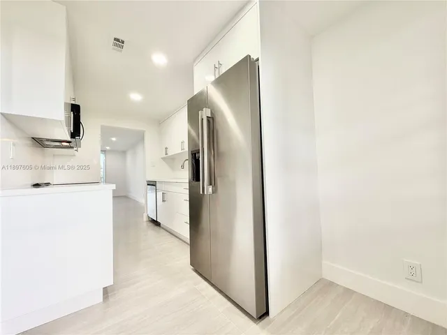 a kitchen with stainless steel appliances a refrigerator and a stove