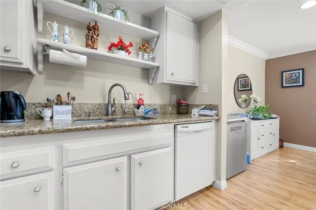 a kitchen with a refrigerator a table and chairs