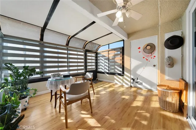a view of a dining room with furniture a chandelier and wooden floor