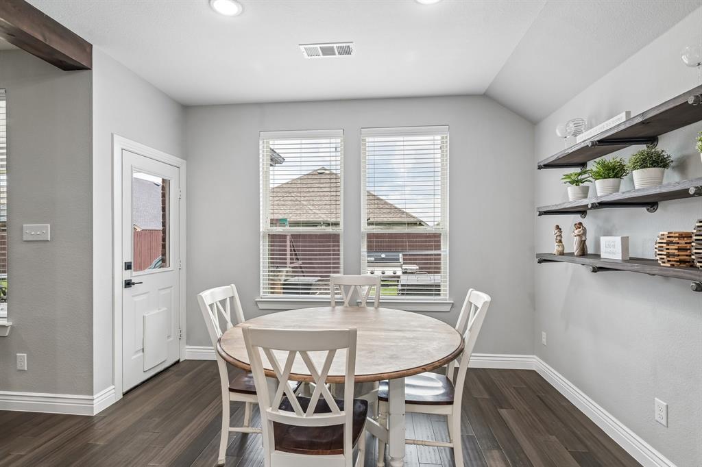 1805 Huntsman Way Forney, TX 75126 - Photo 5 of 34 Wood-finish flooring throughout, recessed ceiling lighting, two double-paned windows with blinds, a side door with a window pane, and wall-mounted wooden shelving with industrial-style brackets