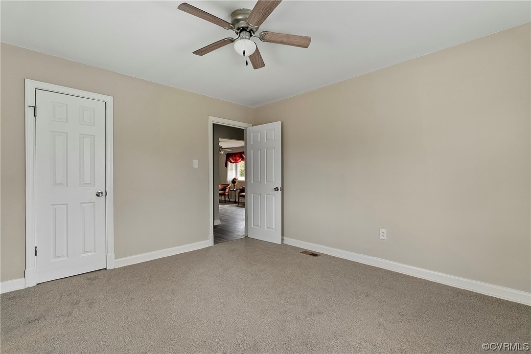 988 3 Notch Road Kents Store, VA 23084 - Photo 24 of 32 Bedroom featuring dark carpet and ceiling fan