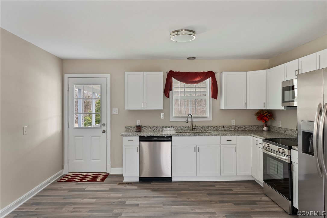 988 3 Notch Road Kents Store, VA 23084 - Photo 7 of 32 Kitchen featuring white cabinets, stainless steel