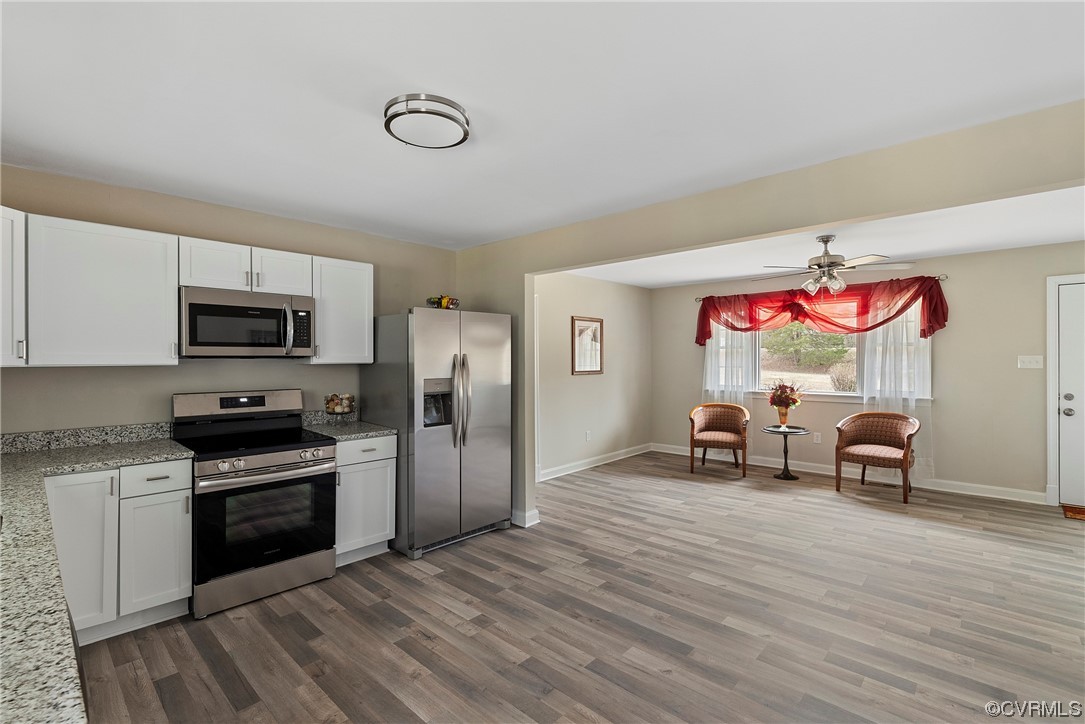 988 3 Notch Road Kents Store, VA 23084 - Photo 10 of 32 Kitchen with LPV flooring, white cabinets, applian