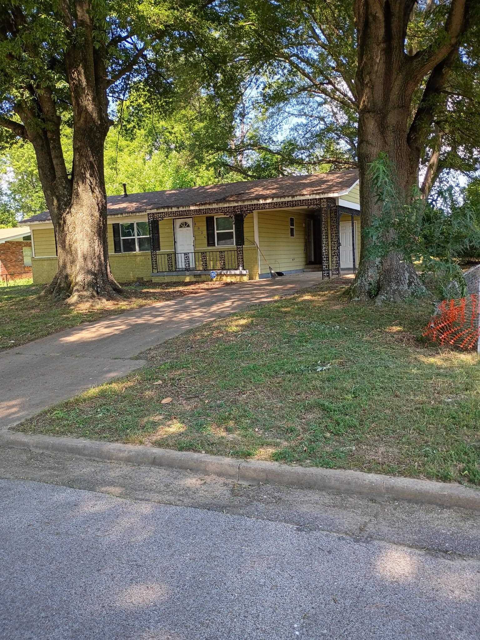 a front view of house with yard and green space